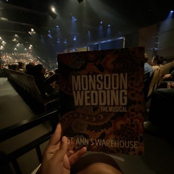 St Ann's Warehouse - a person holding a book in front of a stage - Performing Arts Near Me - Brooklyn, New York St Ann's Warehouse - a person holding a book in front of a stage - Performing Arts Near Me - Brooklyn, New York