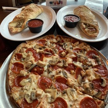 Ryan's Pizza & Pub - Thin crust pizza and one Stromboli cut in half - Irish Near Me - Cocoa, Florida Ryan's Pizza & Pub - Thin crust pizza and one Stromboli cut in half - Irish Near Me - Cocoa, Florida