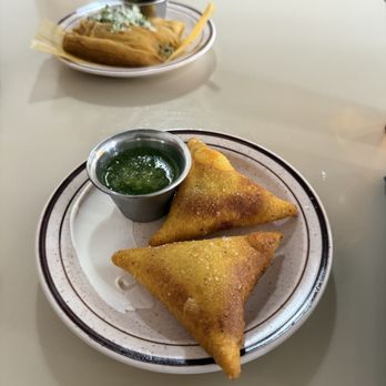 Casimiro - TETELA DE HONGOS AL AJILLO - masa triangle stuffed with roasted mushrooms, deep tried, roasted salsa verde and crema - Mexican Near Me - New Orleans, Louisiana