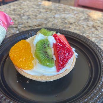 Kneaders Bakery & Cafe - a fruit tart on a black plate - New American Near Me - Twin Falls, Idaho Kneaders Bakery & Cafe - a fruit tart on a black plate - New American Near Me - Twin Falls, Idaho