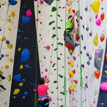 Riverfront Rock Gym - a woman climbing on a rock wall - Gyms Near Me - Wenatchee, Washington