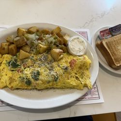 The Mediterranean Omelet with Farmhouse Potatoes, Toast & side of Tzatziki sauce