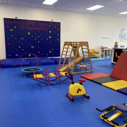 We Rock the Spectrum - Franklin - Rock climbing wall, workout equipment, entrance to the toddler area.