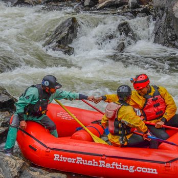 River Rush Rafting - three men rafting, two are giving each other a fist bump to celebrate completing the rapid behind them - Rafting/Kayaking Near Me - Idaho Springs, Colorado River Rush Rafting - three men rafting, two are giving each other a fist bump to celebrate completing the rapid behind them - Rafting/Kayaking Near Me - Idaho Springs, Colorado