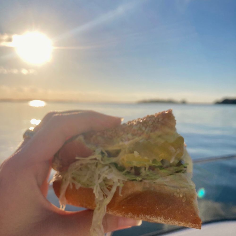 PrimoHoagies - a person holding a sandwich on a boat - Sandwiches Near Me - Mount Pleasant, South Carolina PrimoHoagies - a person holding a sandwich on a boat - Sandwiches Near Me - Mount Pleasant, South Carolina
