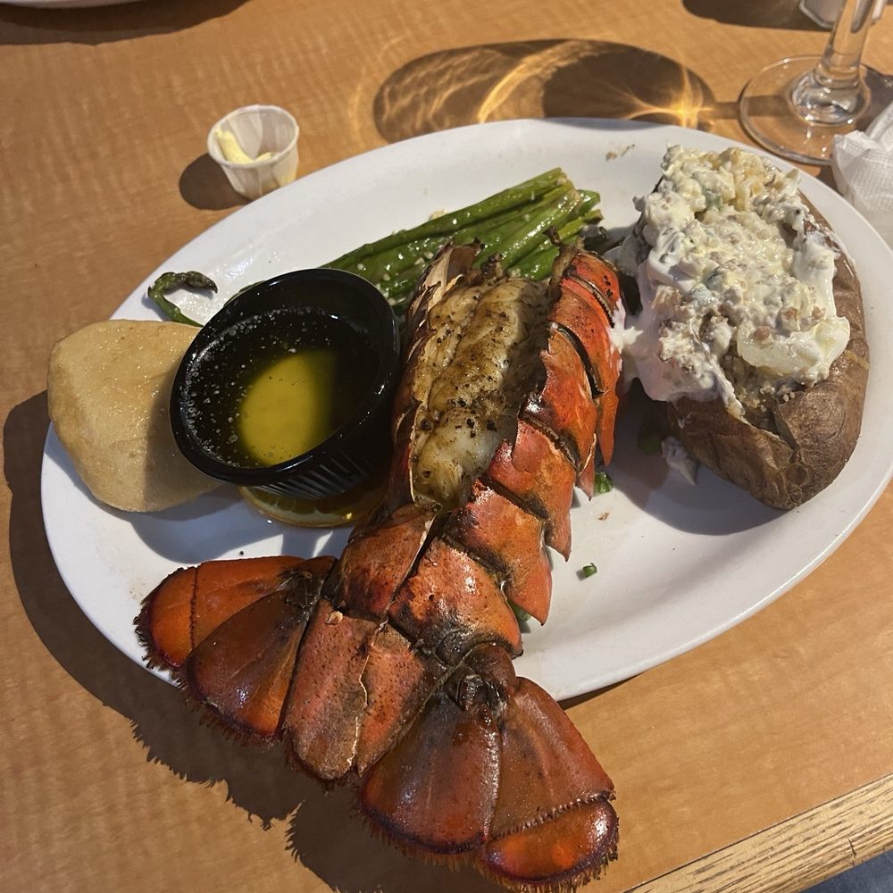 Lobster tail with loaded potato and grilled asparagus. Lobster tail with loaded potato and grilled asparagus.