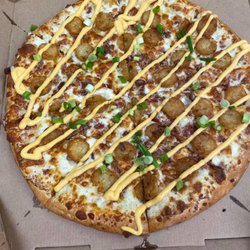 Toppers Pizza - The LOADED TOT-ZZA - a tater tot and cheese pizza with smoked bacon and green onion. That's ranch dressing