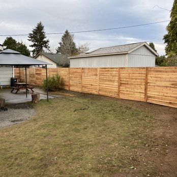 Grassroots Construction - a backyard with a wooden fence - Landscaping Near Me - Lake Oswego, Oregon