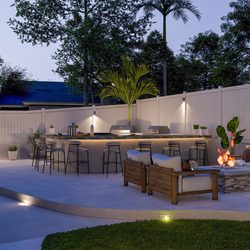 Leon Design & Build - 50-ft luxury outdoor kitchen with top-cast concrete, custom fire pit, and integrated bench seating built for style, comfort, and durability.