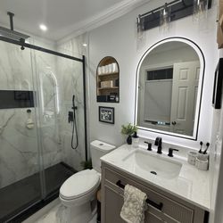 W G Painting & Construction - Bathroom remodel, detailed floor tile, vanity install, LED arched mirror, recessed shelving and shower