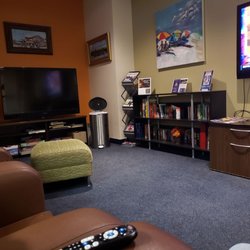 One half of the seating area. Two TVs, a slew of books and movies, and comfortable lounge chairs