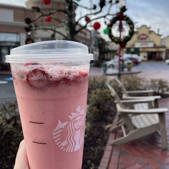 Starbucks - a hand holding up a pink drink in front of a christmas tree - Coffee & Tea Near Me - West Homestead, Pennsylvania Starbucks - a hand holding up a pink drink in front of a christmas tree - Coffee & Tea Near Me - West Homestead, Pennsylvania