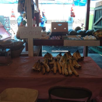 The Strawberry Stand - a bunch of bananas on a table - Farmers Market Near Me - Oxnard, California
