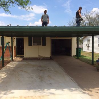 David Helms Services - two men standing on the roof of a house - Tree Services Near Me