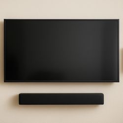 Hang It Up Mounting - Clean and modern wall-mounted TV setup with surround sound speakers for the perfect home theater experience.