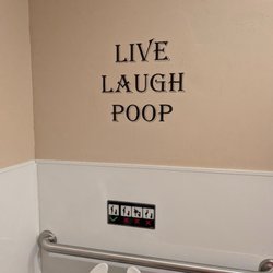 Lucy's New York Style Pizzeria - A bathroom toilet