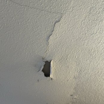1A Garage Doors - The ceiling drywall after the A1 technician started picking at the drywall - Garage Door Services Near Me