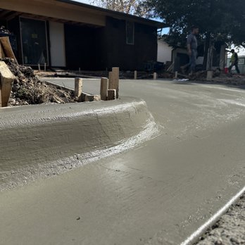 JP Concrete - Finished concrete curb and driveway -- smooth radius, clean lines, and a flawless finish that enhances both function and curb appeal. - Masonry/Concrete Near Me