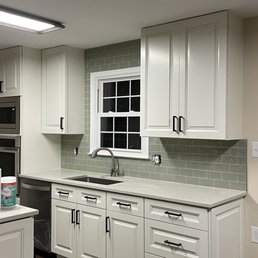 a clean kitchen with white cabinets
