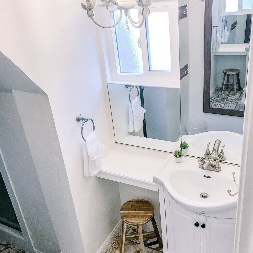 Foreman Construction - a bathroom with a sink, toilet, and mirror - General Contractors Near Me Foreman Construction - a bathroom with a sink, toilet, and mirror - General Contractors Near Me