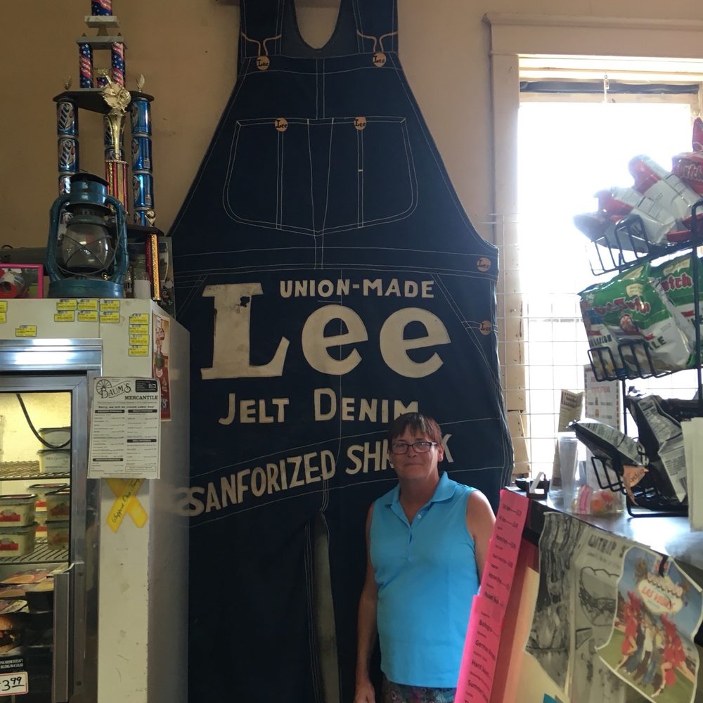 Baum's Mercantile - a woman standing in front of a sign - Grocery Near Me - Pittsville, Wisconsin
