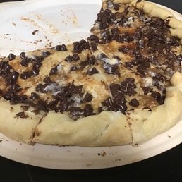 a half eaten pizza on a paper plate a half eaten pizza on a paper plate
