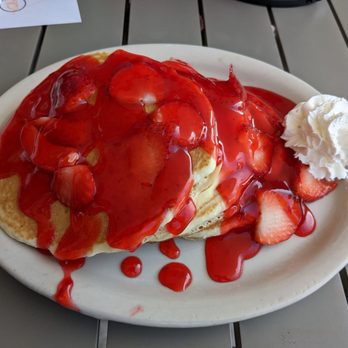 Haneys Cafe - a plate of pancakes with strawberries and whipped cream - Cafes Near Me - Fort Myers, Florida