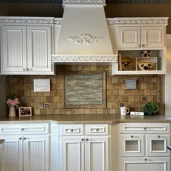 Traditional Floors & Design Center - A small kitchen display at the store. Travertine tile on backsplash and the floors. C Harper made into a custom rug.