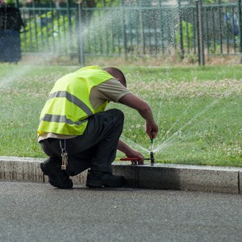 Hodges Irrigation - a man using a sprinkler - Irrigation Near Me Hodges Irrigation - a man using a sprinkler - Irrigation Near Me