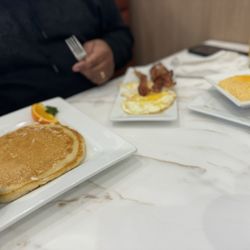 Keke's Breakfast Cafe - Cheese grits, pancakes, eggs fried hard and bacon