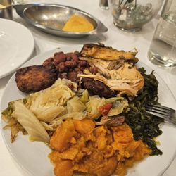 Pearl's Place - Salmon croquette, jerk turkey, candied yams, cabbage, mustard greens, red beans and rice.