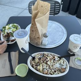 Steak and Chicken bowls with cilantro lime sauce on the side and a small bag of chips. Good sized portions too! Steak and Chicken bowls with cilantro lime sauce on the side and a small bag of chips. Good sized portions too!
