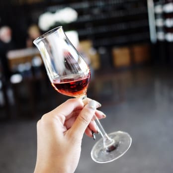 Stratus Vineyards - a hand holding a glass of wine - Wineries Near Me - Niagara-on-the-Lake, Ontario Stratus Vineyards - a hand holding a glass of wine - Wineries Near Me - Niagara-on-the-Lake, Ontario