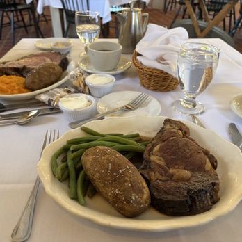 The Wayside Inn - prime rib, baked potato, and green beans in the foreground and prime rib, baked potato, and mashed butternut squash in the background - Hotels Near Me - Sudbury, Massachusetts The Wayside Inn - prime rib, baked potato, and green beans in the foreground and prime rib, baked potato, and mashed butternut squash in the background - Hotels Near Me - Sudbury, Massachusetts