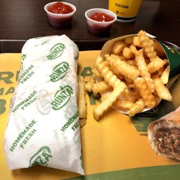 a tray with a sandwich, fries and ketchup a tray with a sandwich, fries and ketchup