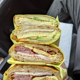 Top is an egg cheese and avocado. Bottom is bacon sausage ham and cheese. Both on a croissant.