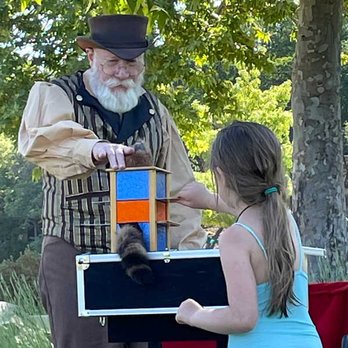 Ric the Magician - Ric performing a magic trick with a puppet. - Magicians Near Me Ric the Magician - Ric performing a magic trick with a puppet. - Magicians Near Me