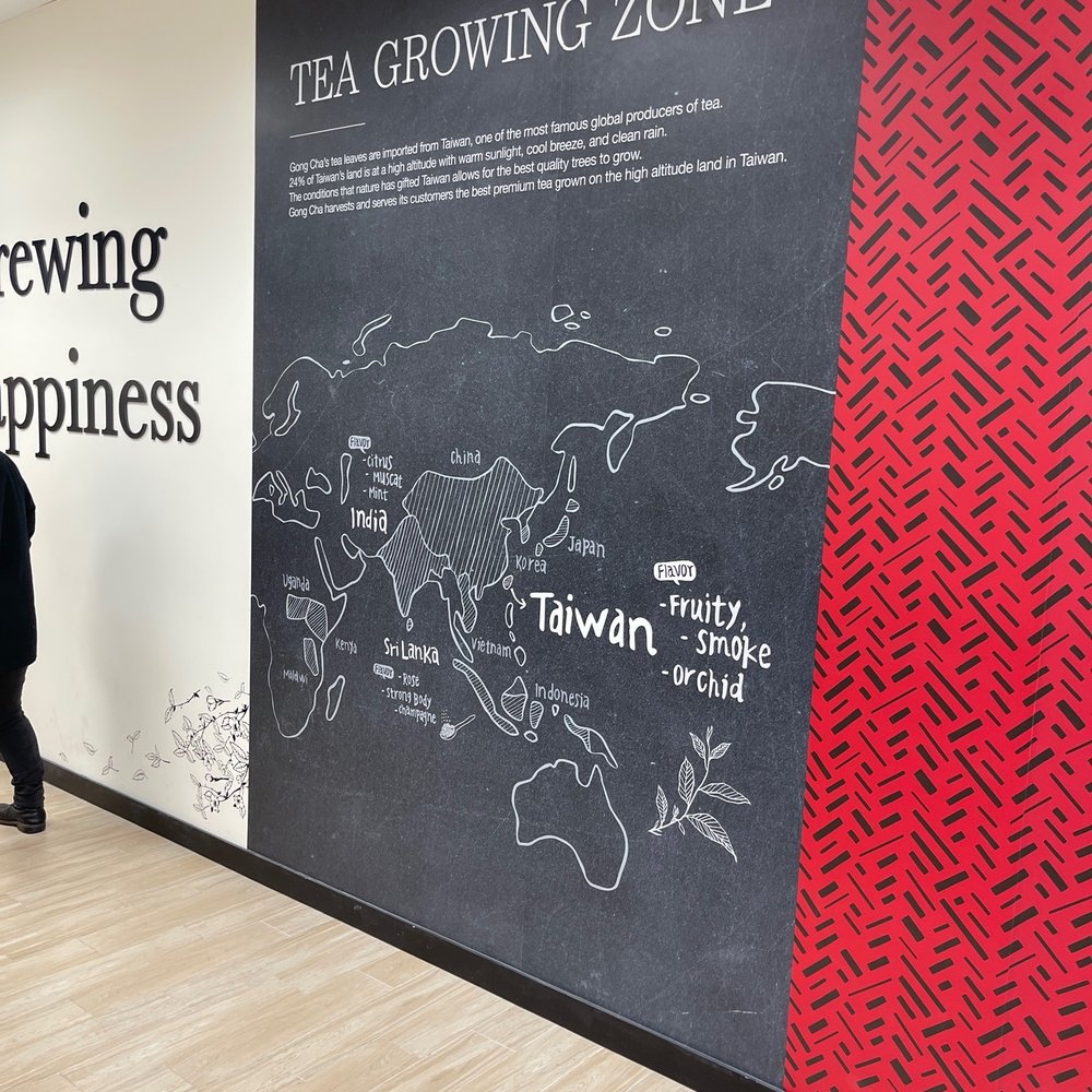 Gong Cha - Plainview - a woman walking past a mural of tea growing zones - Bubble Tea Near Me - Plainview, New York Gong Cha - Plainview - a woman walking past a mural of tea growing zones - Bubble Tea Near Me - Plainview, New York