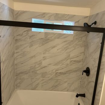 BH  Roofing & Construction - Brand new tiles and bathtub with sliding doors installed - Roofing Near Me