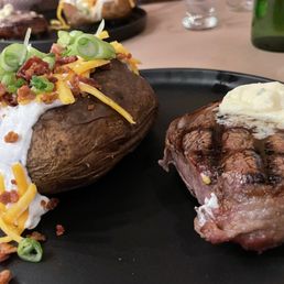 Filet medium rare and loaded backed potato Filet medium rare and loaded backed potato