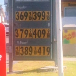 Shell Gas Station - Smaller out of the way on sign ground that actually states the true cost.