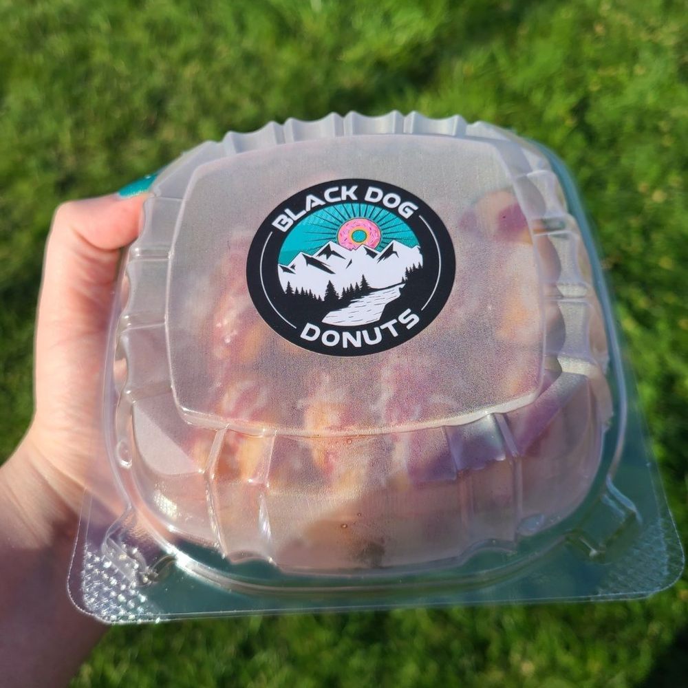 Black Dog Donuts - a hand holding a donut - Food Trucks Near Me Black Dog Donuts - a hand holding a donut - Food Trucks Near Me