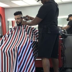 Exclusive Barber Shop - This artist is making this guys hair look super sharp!!!