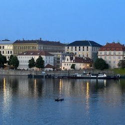 Four Seasons Hotel - View of Four Seasons from Charles Bridge  - it's the one with the red roof and three floors! (May, 2023)