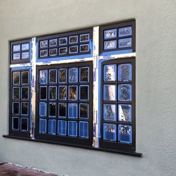 Romano Builders - Front custom casement windows and light panels installed. - General Contractors Near Me