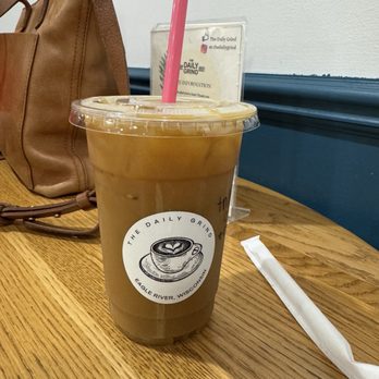 The Daily Grind - Iced oatmilk latte with toffee nut and maple syrup and caramel drizzle - Coffee & Tea Near Me - Eagle River, Wisconsin