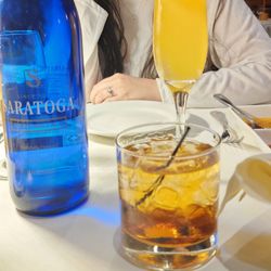 Godfather and Bellini cocktails with a Saratoga sparking water.