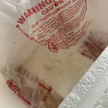 Cajun Grocer - Inside the cooler. Melted, empty three bags of dry ice. Label clearly stating the danger of dry ice. Also at the bottom was crawfish juice. - Grocery Near Me Cajun Grocer - Inside the cooler. Melted, empty three bags of dry ice. Label clearly stating the danger of dry ice. Also at the bottom was crawfish juice. - Grocery Near Me