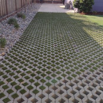Lobo Landscape and Maintenance - a backyard with a lawn made of concrete blocks - Landscaping Near Me Lobo Landscape and Maintenance - a backyard with a lawn made of concrete blocks - Landscaping Near Me