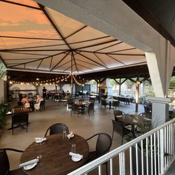 Patio has stringed lights and an outdoor fireplace